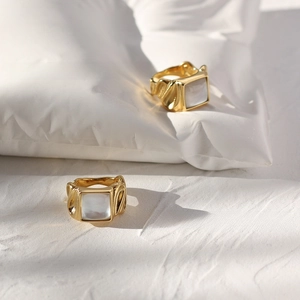 Macro shot of 18K gold plated ring featuring vintage textured band and square shell inlay