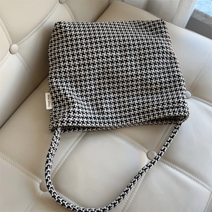 Detail shot of vintage knit tote bag with black and white houndstooth pattern weave