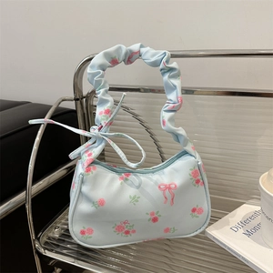 Floral canvas shoulder bag with pink roses, bow details and pleated strap in light blue