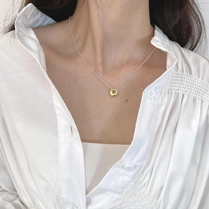Close-up of s925 silver irregular gold oval pendant necklace on a bead chain