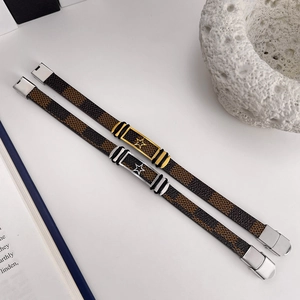 Detail view of leather bracelets with checkered pattern and star metal clasp