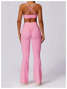 Pink yoga set back view featuring cross-strap sports bra and ruched lifting leggings