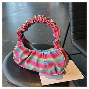 Macro detail of rainbow gradient pleated handbag showing texture and pastel silk finish