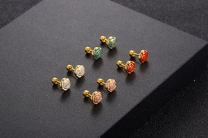 Detailed macro view of 18k gold plated rose earrings in blue red white and pink enamel