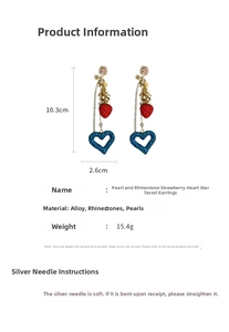 Detailed view of long tassel earrings with strawberry, star charms and pearls