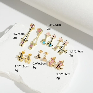 Exquisite bear and celestial themed earring set with rhinestones on white stone