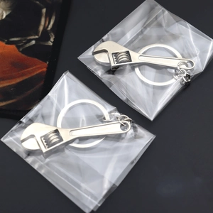 Mini silver metal adjustable wrench keychain with realistic rotating worm gear design