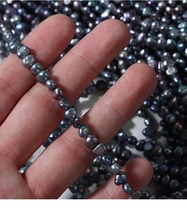 Macro shot of 4-5mm peacock black baroque freshwater pearls for DIY jewelry making