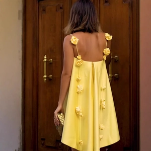 Bright yellow satin slip dress featuring 3D floral accents and elegant backless design