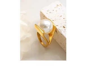 Detailed macro view of large white pearl set in a brushed gold sculptural statement ring