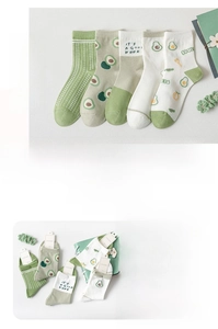 Detail view of avocado green cotton socks set with cartoon prints and stripe patterns