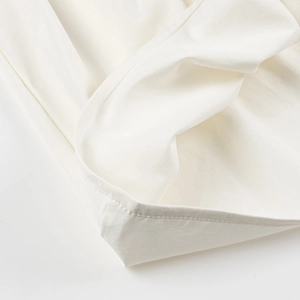 Macro shot of white tank top fabric texture showing premium double stitching detail