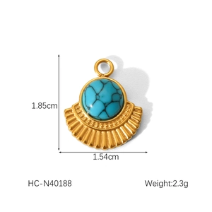 Macro shot of gold fan pendant with turquoise inlay and detailed size specifications