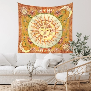 Detail view of Bohemian sun and moon zodiac tapestry hanging above a white sofa