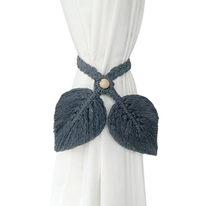 Handwoven bohemian curtain tieback with dark grey leaf tassels and a natural wood bead