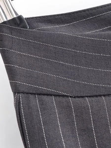 Détail de la taille et de la texture du tissu à rayures du pantalon large