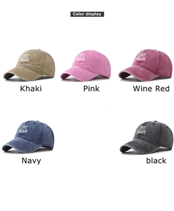 Detail display of embroidered CAT MOM lettering on washed cotton baseball caps in 5 colors