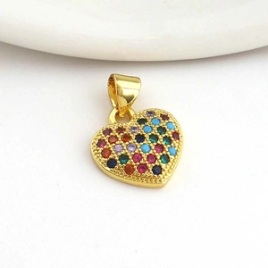 Macro detail of heart pendant with gold plating and colorful pavé cubic zirconia
