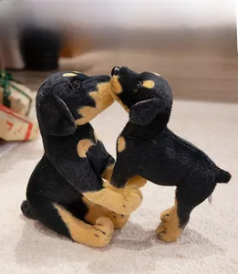 Close-up of realistic black and brown Doberman plush dog dolls in a gift scene