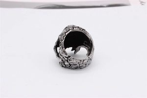 Macro shot of retro stainless steel ring featuring rugged lava texture and hollow interior