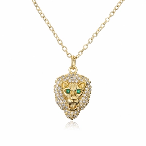 Gold plated lion head pendant necklace with white cubic zirconia and green gem eyes