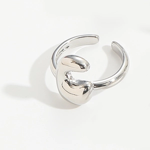 Macro detail of silver adjustable open ring with minimalist organic irregular metal texture