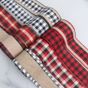 Detail of Christmas faux linen ribbons featuring classic red, black, and white plaid patterns