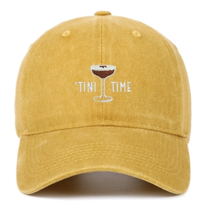 Detailed close-up of Tini Time and cocktail embroidery on yellow washed cotton cap