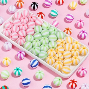 Close-up of colorful striped acrylic beads in various candy colors for DIY jewelry making