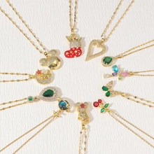 Detailed close-up of various gold-plated necklaces with heart, drop and pearl pendants
