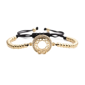 Bracciale a sfere dorate con ciondolo infinito in zirconi bianchi e cordino nero