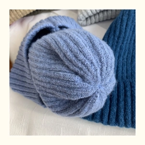 Detailed close-up showing knit wool texture and Morandi color selection for beanies