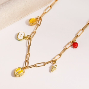 Detail showing gold paperclip chain necklace with colorful enamel fruit pendants