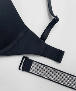 Close-up of black bra straps featuring luxury silver rhinestone detailing and adjustable buckles