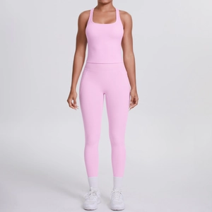 Pink two-piece yoga set with racerback crop top and high-waisted leggings with pockets