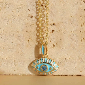 Detailed macro view of the gold-plated Evil Eye pendant with blue enamel and zircon inlay