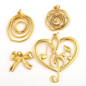 Detailed view of gold stainless steel charms in heart, bow, and sea-themed shapes