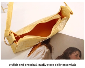 Top view of bright yellow baguette bag showing interior capacity and crocodile pattern