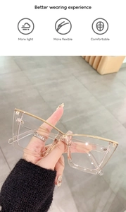 Detail of lightweight cat-eye glasses showing gold metal temples and transparent frames