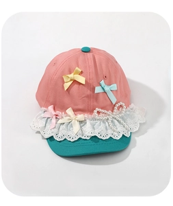 Detail of pink and blue kids sun hat with lace edge and pearl bow decoration