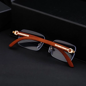 Detail of luxury wood grain temples with golden C-shape metal hinge on rimless sunglasses