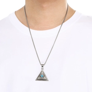 Detail of vintage silver Viking pendant with blue all-seeing eye on a white shirt
