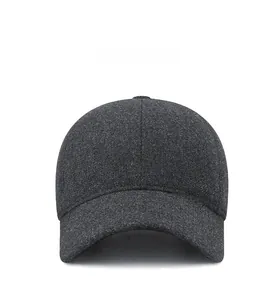 Front view of thick wool blend baseball cap in dark grey with metal logo and ear protection