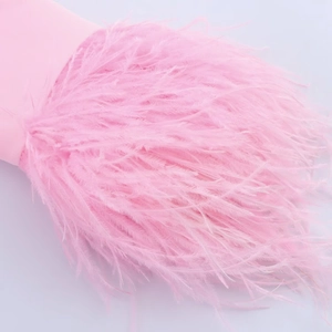 Close-up of pink fluffy feather trim detailing on the sleeve cuff of a stylish suit jacket