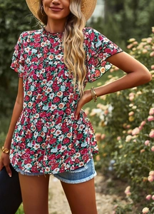 Detailed view of women's floral print top with ruffle sleeves and tiered hem design