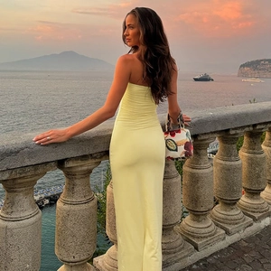 Detailed close-up of pale yellow ruched fabric on the U-neck bodycon maxi dress