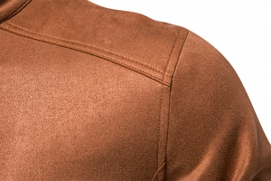 Close-up of double-needle stitching on camel suede jacket shoulder area