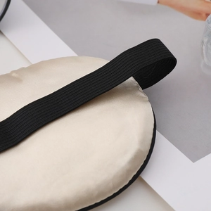 Champagne silk sleep mask with black elastic strap for light blocking and eye protection