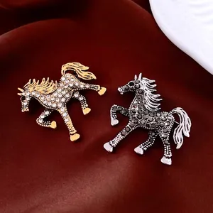 Luxury horse brooches in gold and silver colors with rhinestones on velvet background