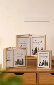 Detailed view of rotating double-sided wooden photo frames in various sizes and natural grains